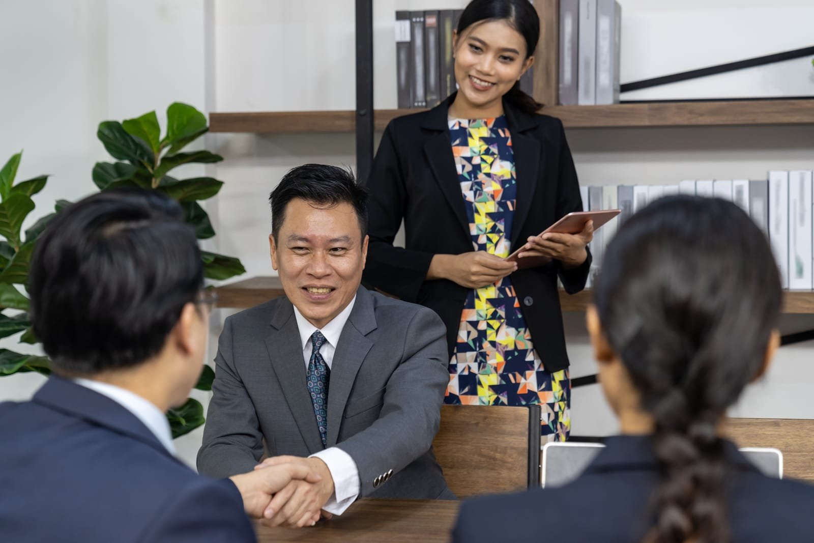 77681494_business-deal-in-a-cafe merger and acquisition deal